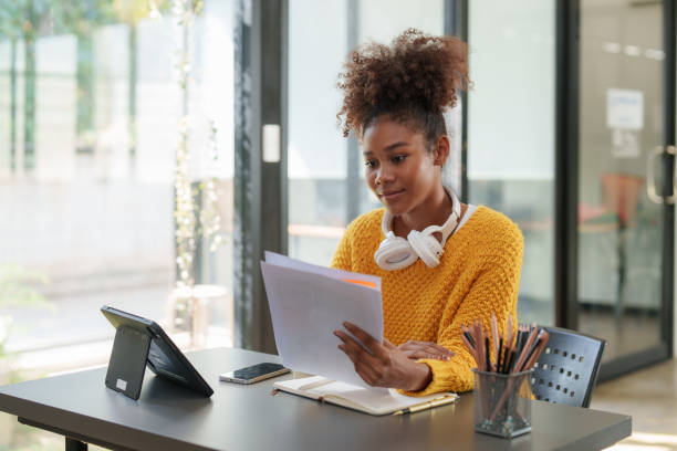 istock Young black curly hair American African woman using digital tablet 1462959491