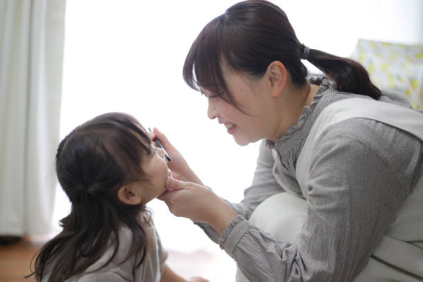 istock mother brushing child's teeth 1462962295