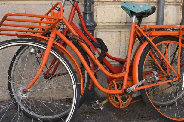 istock Old red bicycles parked at street 1462962346
