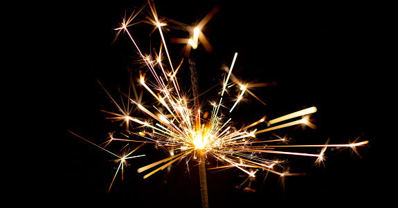 Sparklers on Christmas lights background