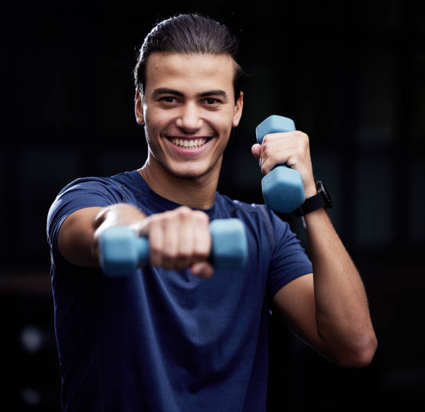 portrait, fitness or man boxing with dumbbell for strength training, workout or cardio exercise in gym in mexico. smile, face or happy athlete boxer with sports champion pride or warrior mindset - healthy lifestyle men boxing dumbbell imagens e fotografias de stock