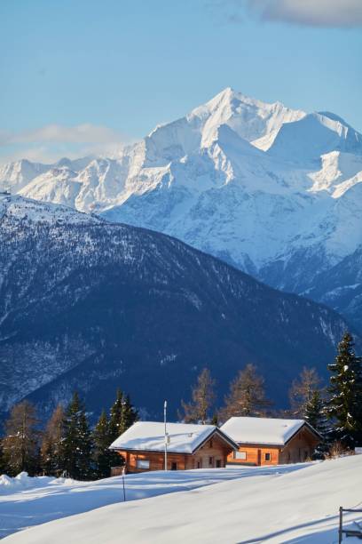 istock Vertical shot of the small huts nestled between the snowy mountains 1462968012