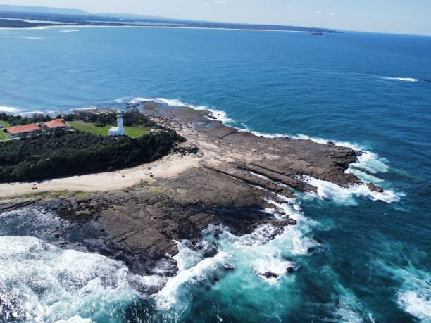 istock Bird's eye view of a white lighthouse on a rocky coast 1462968653