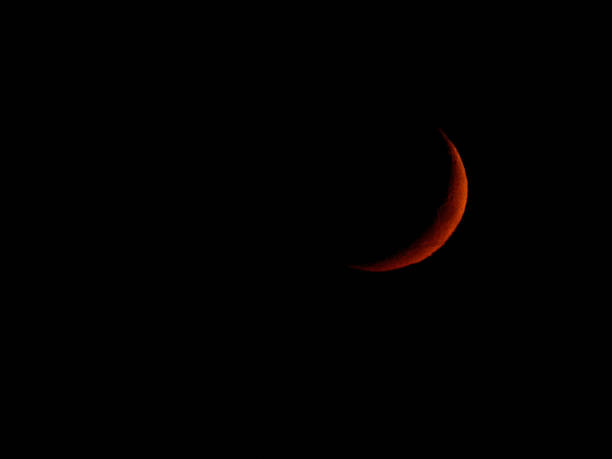 istock Closeup shot of a red crescent moon on a completely black sky 1462969071