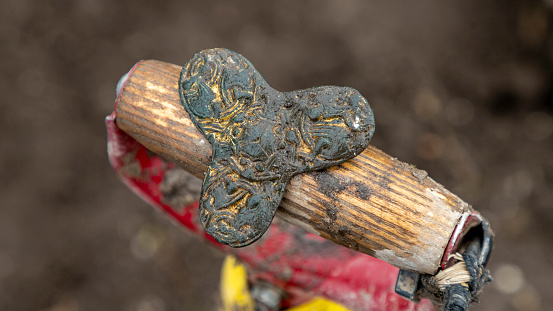 A closeup shot of Viking Age fibula, intact, bronze