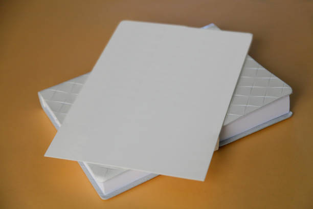 istock White blank paper envelope on top of notebook isolated on a gold background 1462977943