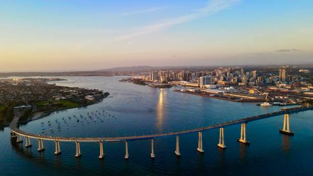 coronado landmark bridge offering picturesque views of the city skyline & passing naval ships - naval ship imagens e fotografias de stock