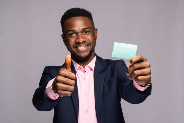 istock Black man smiling showinga tumbs up and a plain card 1462978655