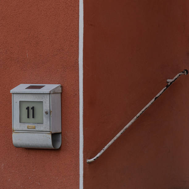 istock Closeup of a metal mail letter box on a red wall 1462979644