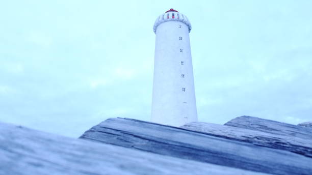 istock Closeup of a lighthouse with light cloudy sky background 1462979656