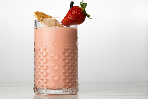 strawberry smoothie with natural fruit, white background and copy-space