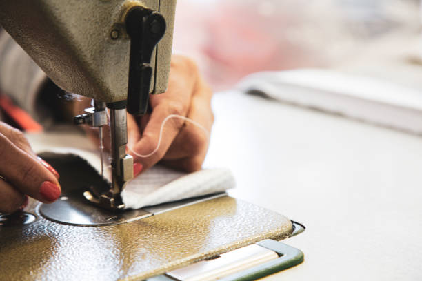 istock Closeup of hands sewing a fabric with a sewing machine 1462980771