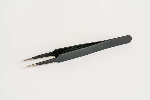 Tweezers on a white background