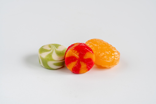 A set of colored jelly beans on a white background.