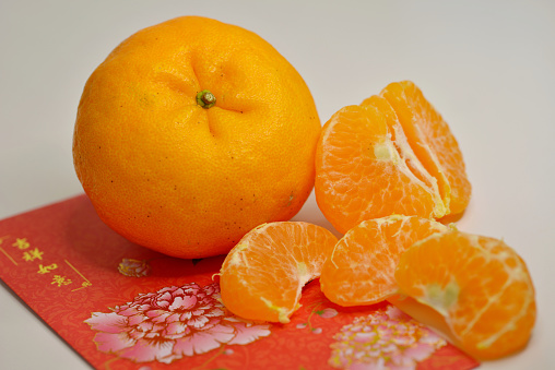 The tradition of exchanging mandarin oranges during Chinese New Year originated from South China and confers prosperity, well wishes to the recipient.