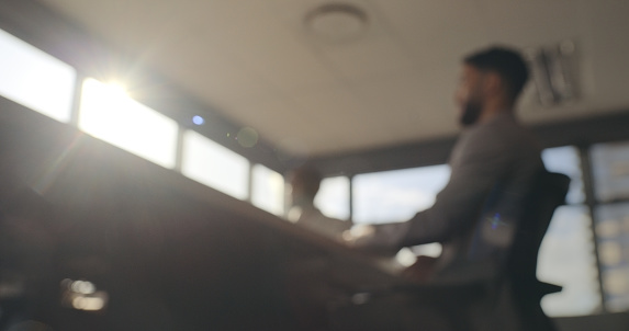 Conference meeting, business people and blurred background in office, corporate and company planning. Seminar, lens flare and boardroom from below for career negotiation, strategy and collaboration