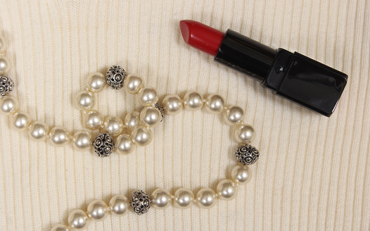 Pearls and Red Lipstick on White Sweater Closeup