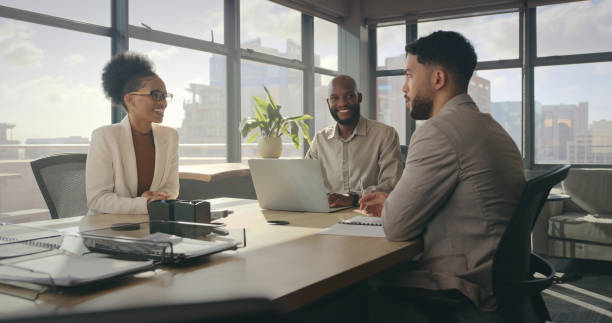 Negotiation, company meeting and corporate team talking about investment proposal or b2b contract deal. Communication, finance conversation and teamwork collaboration of happy African business people stock photo