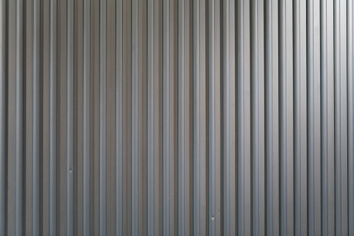 Seamless vertical metallic pattern of grey or  light blue corrugated metal wall for background and texture high resolution for designing and backdrop