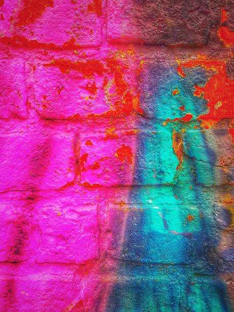 istock Closeup of a vibrant peeling paint on red brick wall 1462988660
