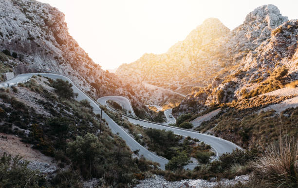 istock Curving road on mountains during sunrise 1462991171