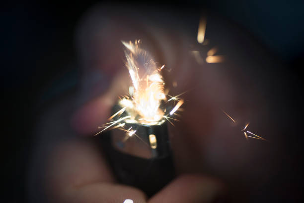 istock Closeup of a black lighter with fire sparks 1462991845