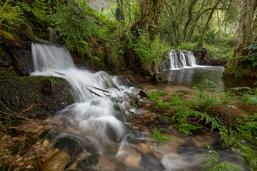 A small waterfall formed by the river Tripes in the natural park of Mount Aloia Park in Galicia, Spain