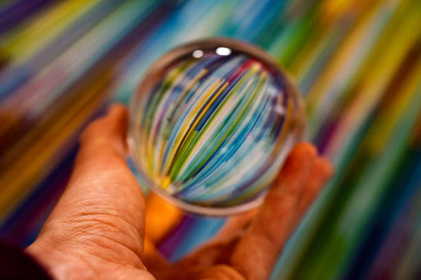 istock Closeup of a glass circle in a hand 1462994928