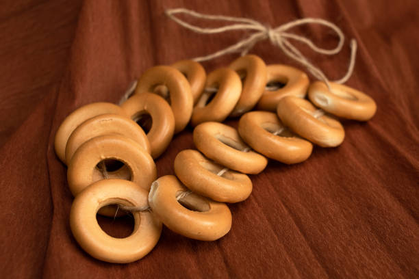 istock A bundle of bagels on a thread, lying on brown corrugated paper. Baking for dessert 1462997106