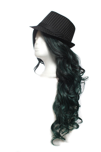 A vertical shot of a classic Fedora hat on mannequin head