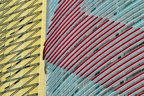 A low angle closeup shot of the two abstract buildings with yellow, blue and red facades