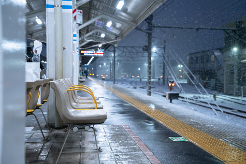 Empty seats at a train station in Tokyo on a cold winter day at night