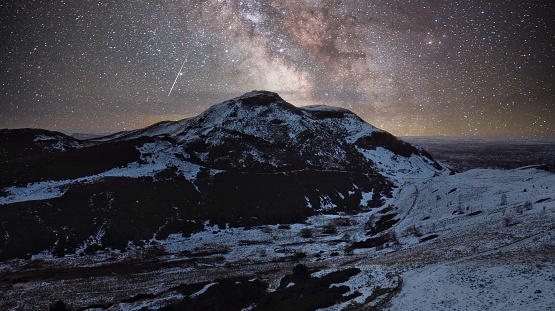 A beautiful shot of the Milky Way over snowy mountains