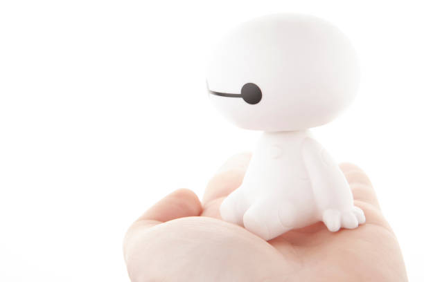 image of plastic toy hand white background