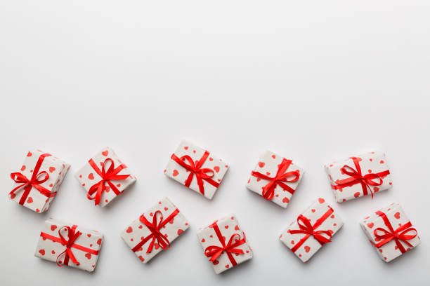 istock Valentine day composition: red gift box with bow and heart. Christmas present. View from above. Space for text. Holday greeting card 1463028387