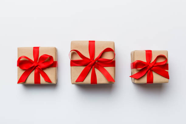 istock Valentine day composition Background: red gift box with bow and heart. Christmas present. View from above. Holday greeting card 1463028452