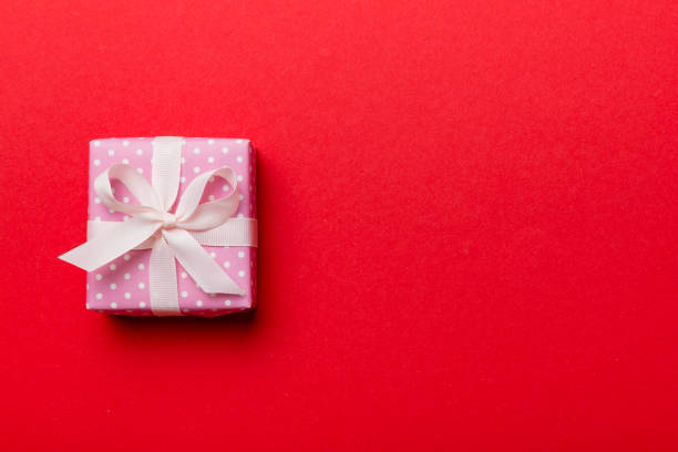 istock Valentine day composition: red gift box with bow and heart. Christmas present. View from above. Space for text. Holday greeting card 1463028482