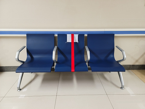 Chairs with social distance markers in clinic