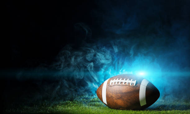 Ball for American football on a sports graund. USA game. Copy space. Ball for American football on a sports field . USA game. Copy space. football field night american culture empty stock pictures, royalty-free photos & images