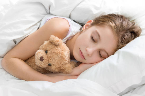 istock child hugging her teddy bear in sleep 1463049146