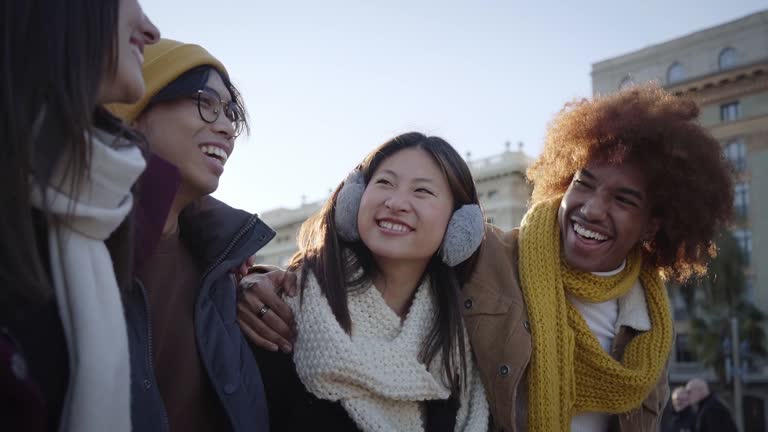 Portrait of Mixed race group of happy friends walking together and having fun in winter clothes