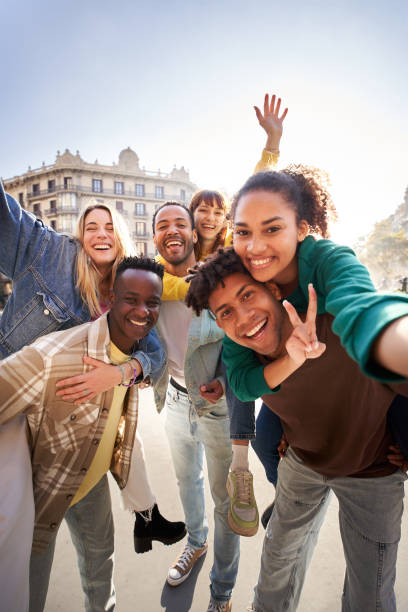 Vertical selfie of A group of cheerful students college friends travel through European cities. stock photo