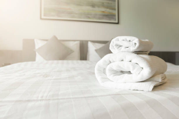 istock The White towel on bed decoration in bedroom interior - Vintage light Filter 1463052269