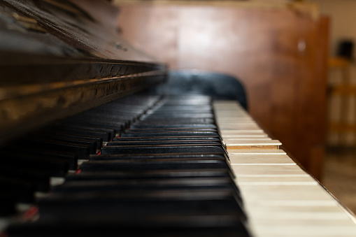 Keys of an antique piano, view from the keys.