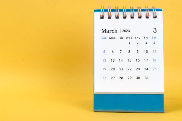 istock March 2023 desk calendar on yellow color background. 1463052976