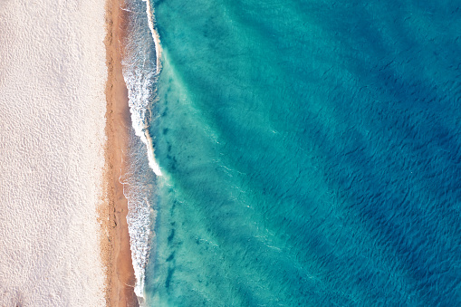 Beach view from a drone. A wonderful summer landscape, clean sand and blue water.