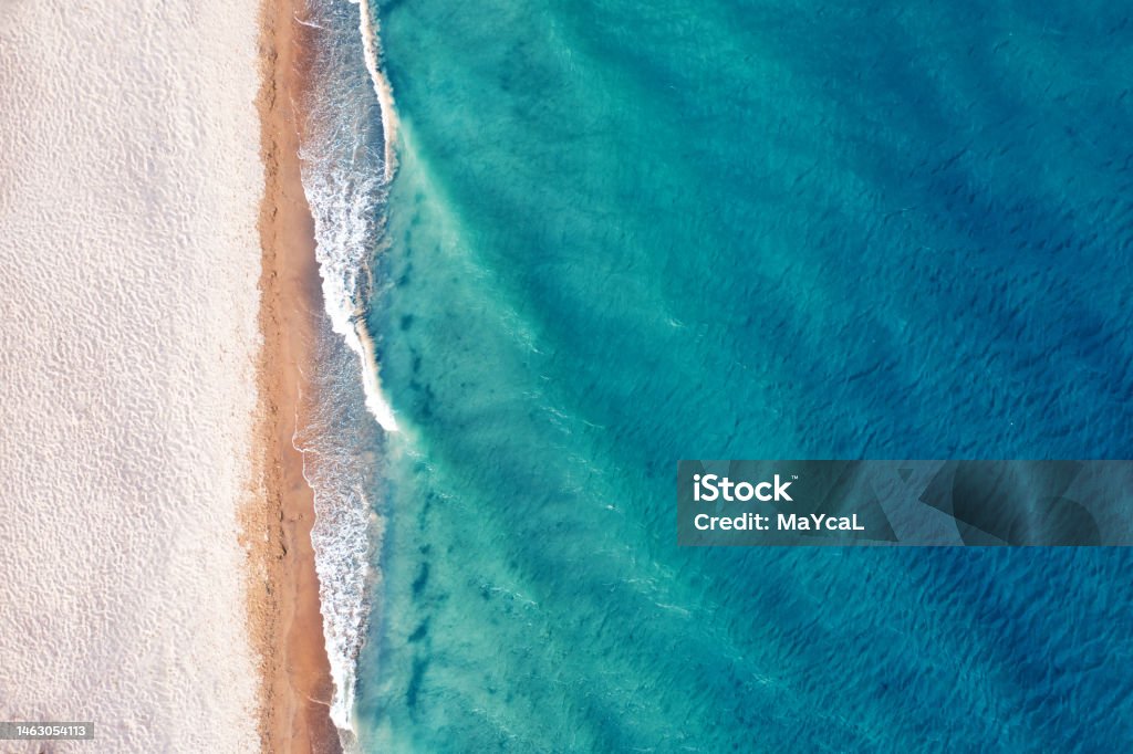 Beach view from a drone. wonderful summer landscape, clean sand and blue water. Beach view from a drone. A wonderful summer landscape, clean sand and blue water. Sea Stock Photo