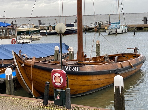 Volendam, Netherlands - January 06, 2023. Historic fishing Vessel in the harbour of the  city Volendam on a cold day in January