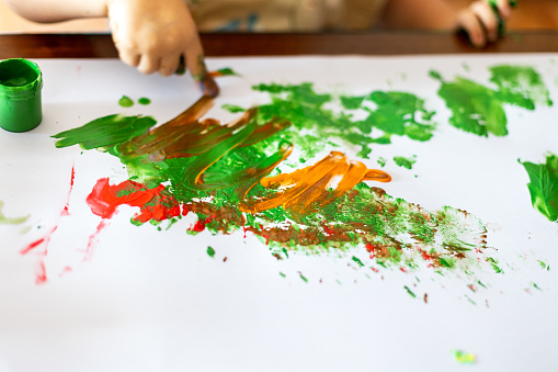 Boy plays with finger paint