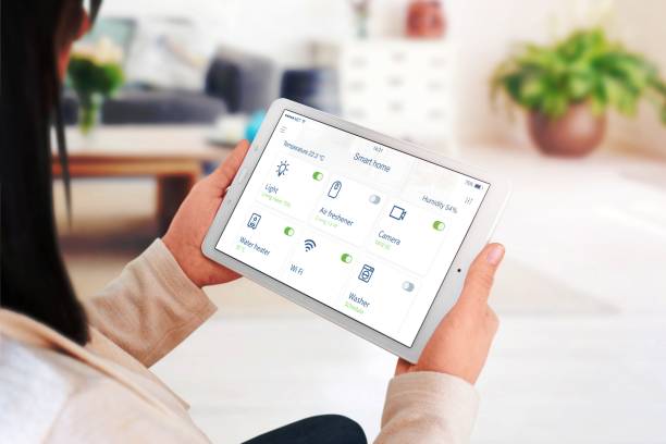 istock Home devices control on modern smart home app on tablet display in woman hand concept 1463067272